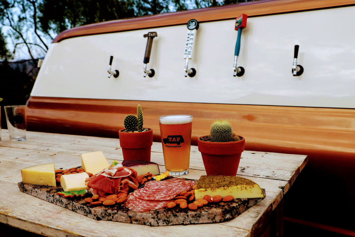 A nice spread of cheese, crackers and meats at this mobile bar to pair with your craft beers.